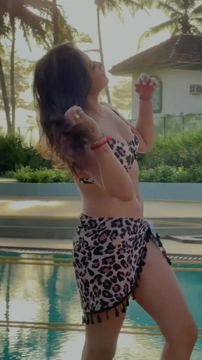Indian babe shows off her thighs, belly button, cleavage, and bikini
