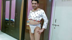 Hot crossdresser femboy Sweet Lollipop in a white crop top and thong.