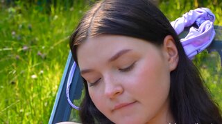 Blushy, small-tittied babe masturbates in the open air