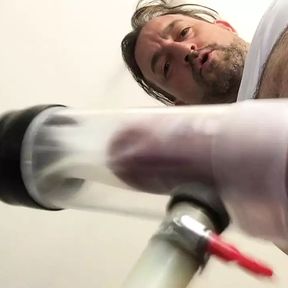 Milking machine sucks big cock while standing