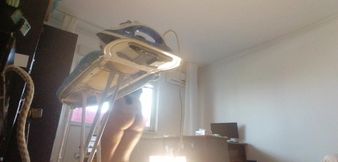 Sexy wife doing housework naked. Brunette, hairy pussy, big ass, big tits. Sexy mom massages herself with a vibrator.