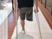 Amputee guy walking with crutches