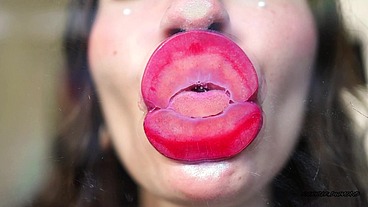 Wet red sticky lipgloss kiss
