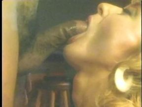 Watch blonde MILF get on her knees in  bar and suck a black cock