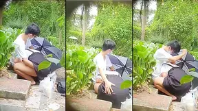 Young Chinese couple having oral sex in park