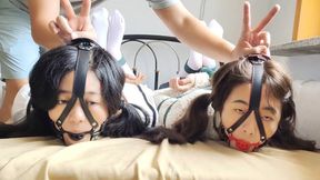 Two girls wearing white stockings were gagged, arms and legs tied and torment