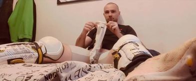Hockey player jacking off in shinpads and cleats with his glove covered hands