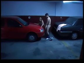 Busty blonde cheats in the garage on the car hood