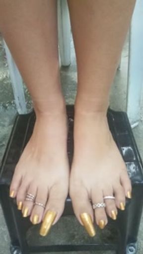 My golden nail polish on my longtoenails