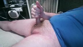 Chubby guy strokes his tight hairy dick until cum drips down his fat belly