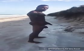 Muscle black man pissing on the beach