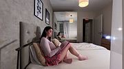 Pink lace panties and a short college skirt with socks to show thick legs and calves on the bed this cute beauty