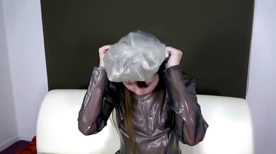 Japanese woman in shiny PVC dress explores breathplay and self-bondage on white leather couch