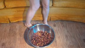 Fifi stomps on a full bowl of grapes with her bare feet until she mashes them all into liquid