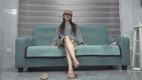 Meng Meng dangles her slippers