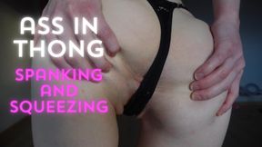 Ass in thong, squeezing and spanking it