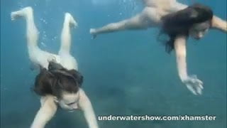 Julia and Masha are swimming nude in the sea