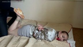 Ballgagged barefoot Amanda in grey shirt and shorts, hogtied with her thumbs tied up, is getting her feet oiled and tickled (HD WMV)