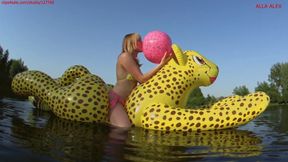 Alla rides on an inflatable cheetah on the lake and inflates a beach ball with her mouth and plays!!!