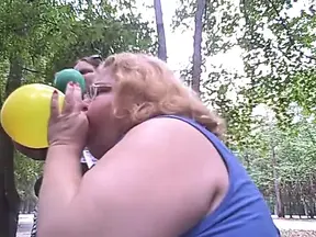 BBW outdoors enjoys a balloon blow-up and popping