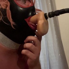 Sissy gagged on a huge dildo while licking the balls