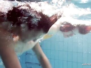Mia and Petra disrobe eachother in the swimmingpool