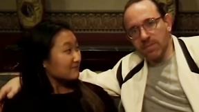 ”Sensual Asian teen has her butt screwed by two guys on couch”