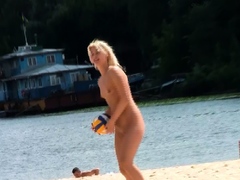 Adorable nudist teen friends enjoy sunbathing at the beach