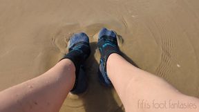 Fifi getting her socks all sandy and wet on the beach