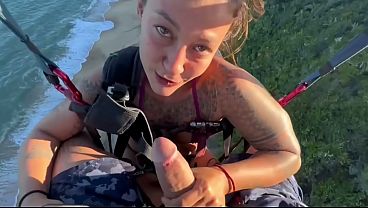 Brunette MILF gives wet blowjob to big cock on a paragliding platform