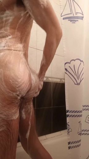 Hairy guy lathering himself in the shower