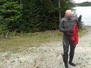 wetsuited silicone masked man on patrol near lake