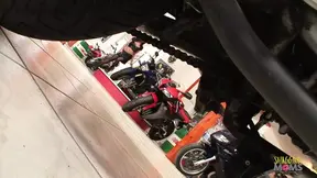Two busty babes get horny at the bike store