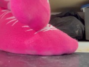 Playing with my pink weed socks under the table
