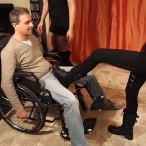 Obedient slave in the wheelchair gets bad spanking from 2 cruel dominatrix