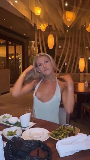 Blonde woman in a sleeveless top at a restaurant