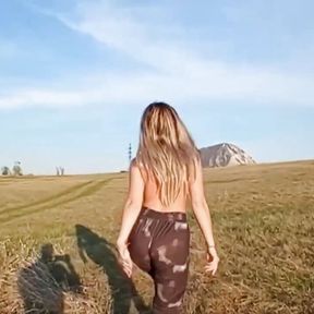 A Girl with a Beautiful Body Poses in a Field