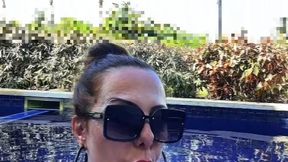 Fat stepmother smoking a cigar by the pool