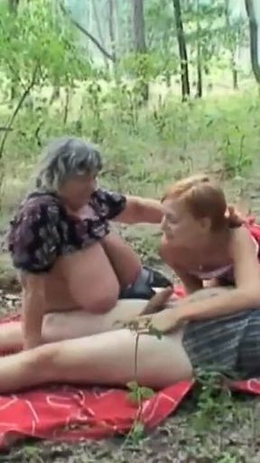 The girl looking for mushrooms sees an older lady with big tits fucking with her old husband and gets very horny