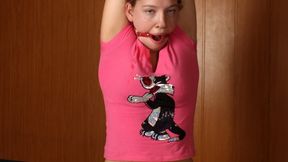 Barefoot ring-gagged Sharon in pink t-shirt and black shorts, frogtied with violet hemp rope, is being pulled up to standing on her knees and teased by the man (HD MOV)