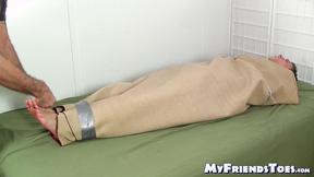 ”Mature master tickles feet & body of a bound slave hunk”