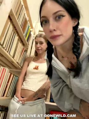 Tattooed Babes with Pigtails Tease in Library