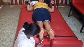 Eli provokes laughter by tickling Anyeli's feet!