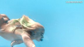 Golden goddess Lisi dives into wet poolside paradise, sultry nakedness exposed