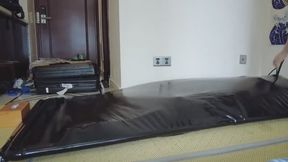 Latex crossdresser sealed in a vacuum bed