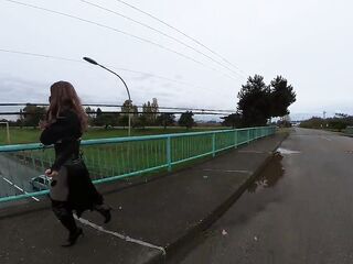 Crossdresser flashing on a highway bridge