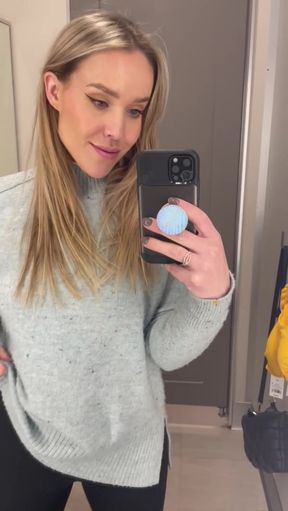 Woman in sweater taking selfie