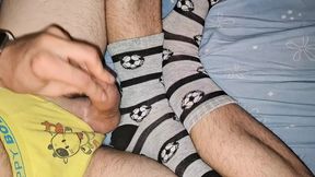 I was playing with my cock after school, wearing yellow underwear and socks which I've covered with cum!