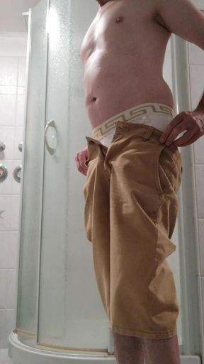 Strip in the bathroom with cockring around the balls and cumshot on the living room couch