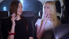 Two Women Smoking and Chatting in a Car at Night